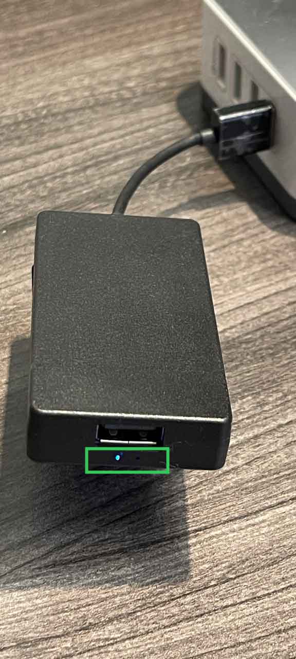 AACP dongle with blue LED lit, indicating a phone is connected via Wi-Fi