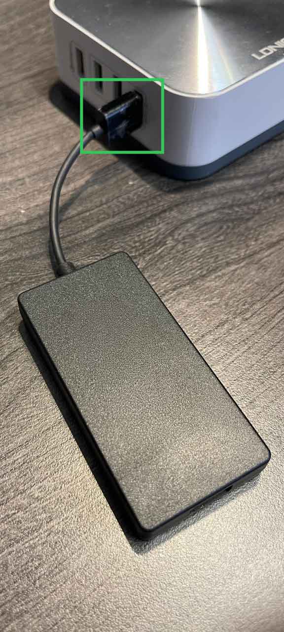 AACP dongle plugged into a USB-A port on a charging hub