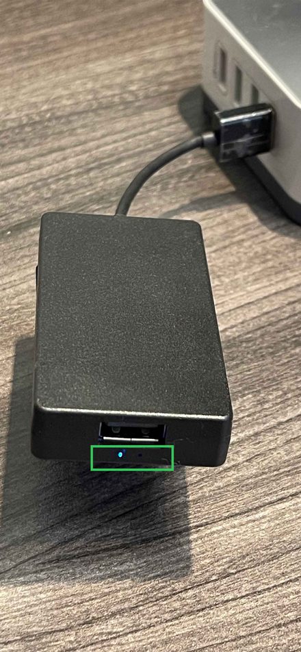 AACP dongle with blue LED lit, indicating a phone is connected via Wi-Fi