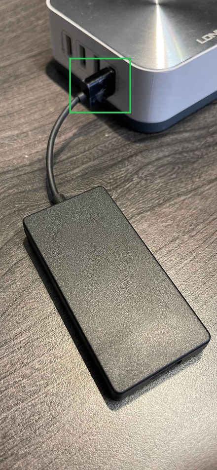 AACP dongle plugged into a USB-A port on a charging hub